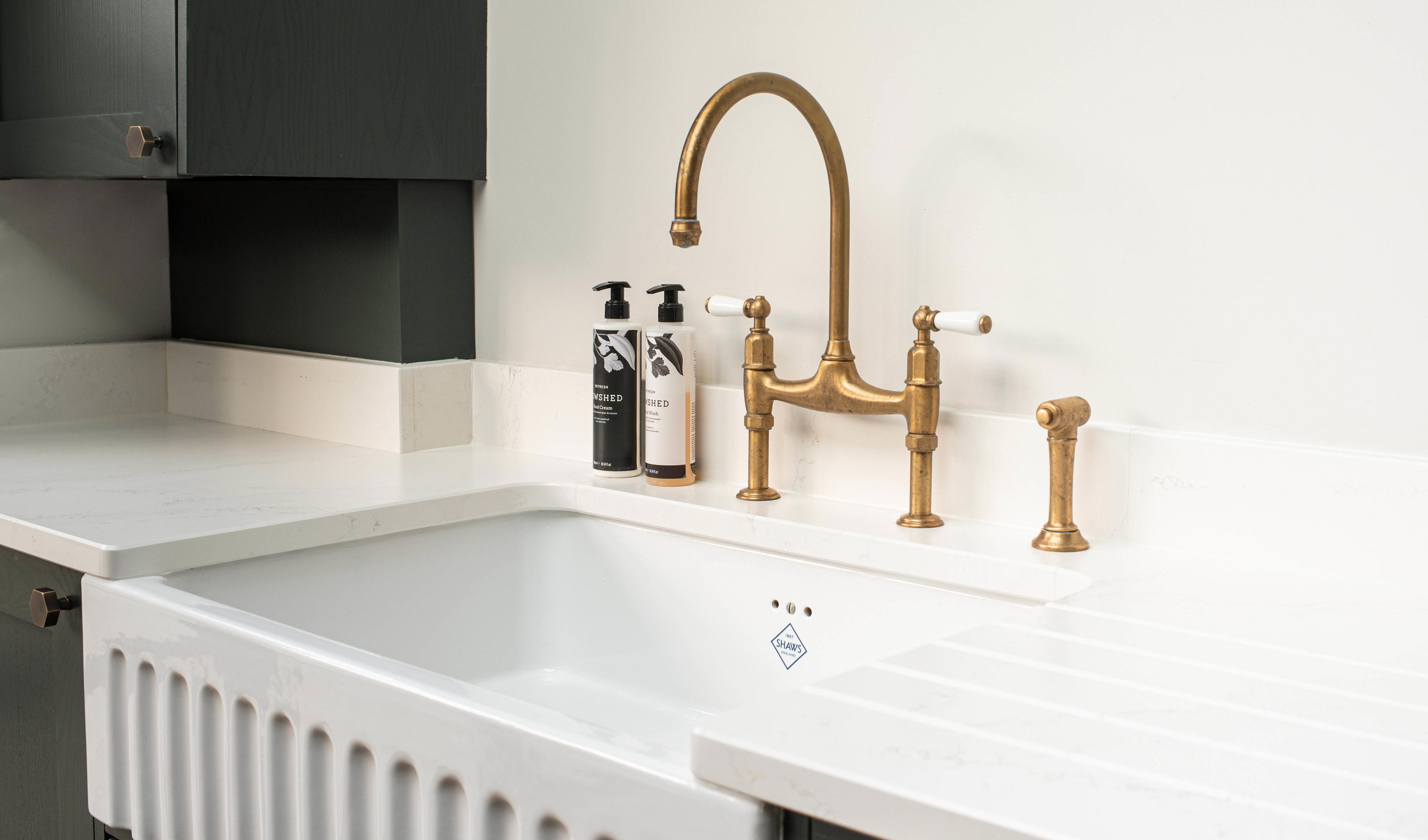 The brassware selected for the main sink was a deck-mounted Ionian tap with a separate pullout spray rinse by Perrin & Rowe. The satin brass is a living finish, which develops its own patina over time.